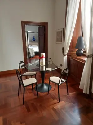 a dining room with a glass table and two chairs at Princess house Roma in Rome