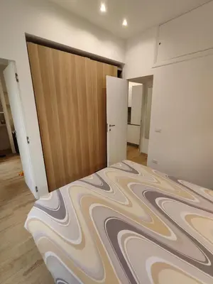 a bedroom with a bed and a wooden door at Casa Aventino in Rome