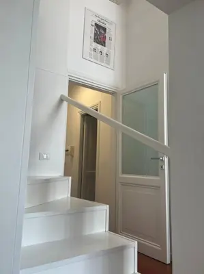 a room with white shelves and a door at Scarpetta32 - Your home in Trastevere in Rome