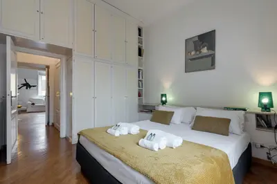a bedroom with a bed with towels on it at Rome As You Feel - Two-Bedroom Apartment in Monti in Rome