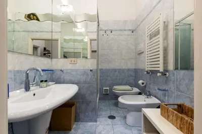 a bathroom with a sink and a toilet and a mirror at Rome As You Feel - Two-Bedroom Apartment in Monti in Rome