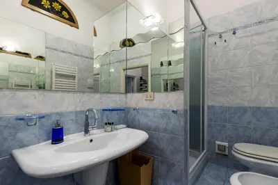 a bathroom with a sink and a shower and a toilet at Rome As You Feel - Two-Bedroom Apartment in Monti in Rome