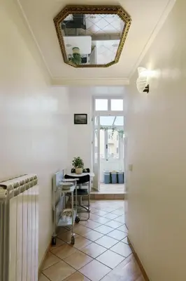 a hallway with a table and a mirror on the ceiling at Rome As You Feel - Two-Bedroom Apartment in Monti in Rome