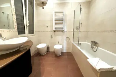 a bathroom with a sink and a tub and a toilet at Spacious and Bright in Rome
