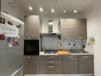 a kitchen with a stove and a refrigerator at Spacious and Bright in Rome