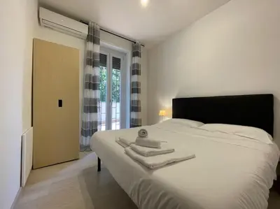 a bedroom with a large white bed with towels on it at Spacious and Bright in Rome