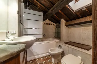 a bathroom with a sink and a toilet and a tub at GuestHost - Cozy Trevi Romance in Rome