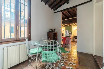 a dining room with a table and chairs at GuestHost - Cozy Trevi Romance in Rome