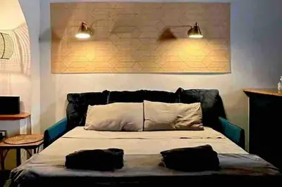 a bedroom with a bed with two black pillows on it at Farnese Muse in Rome