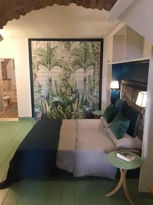 a bedroom with a large bed and a mural at Farnese Muse in Rome
