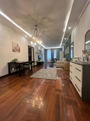 a living room with a kitchen and a dining room at Casa vacanza “Eden” in Rome