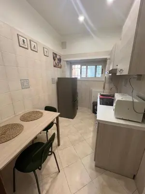 a kitchen with two chairs and a table and a counter at Casa vacanza “Eden” in Rome