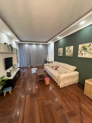 a living room with a couch and a wooden floor at Casa vacanza “Eden” in Rome