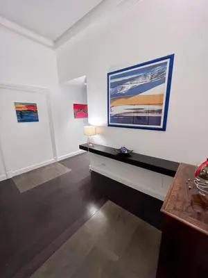 a living room with white walls and paintings on the wall at B&B Azuni Home in Rome
