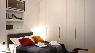 a bedroom with a bed with towels on it at B&B Azuni Home in Rome