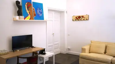 a living room with a couch and a television at B&B Azuni Home in Rome