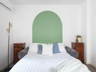 a bedroom with a white bed with blue and white pillows at The Best Rent - Large apartment a few steps from the Trevi Fountain in Rome