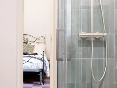 a bathroom with a shower with a bed in it at The Best Rent - Large apartment a few steps from the Trevi Fountain in Rome