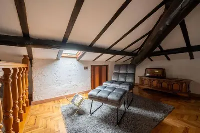 a living room with a leather chair and a table at Guest house Sempione da Giulio in Rome
