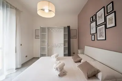 a bedroom with a large white bed with towels on it at Guest house Sempione da Giulio in Rome