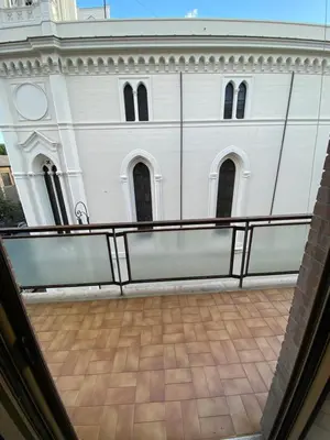 a view of a white building from a balcony at Domus romae esquilini in Rome