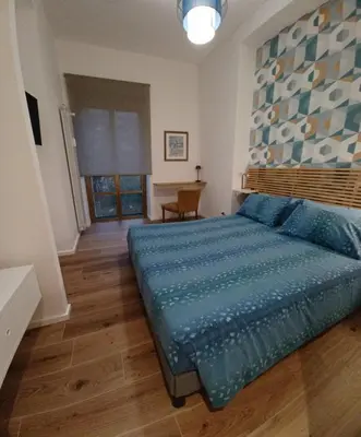 a bedroom with a large blue bed in a room at MT apartment in Rome