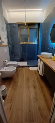 a bathroom with two sinks and two toilets at MT apartment in Rome