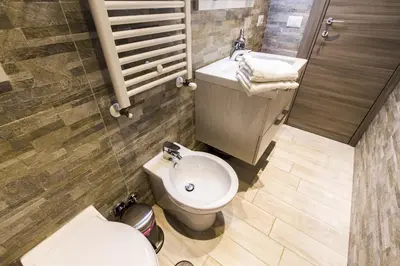 a bathroom with a toilet and a sink at Colossehome - Dream House around the corner from Colosseum in Rome