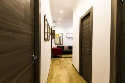 a hallway with a door leading to a living room at Colossehome - Dream House around the corner from Colosseum in Rome
