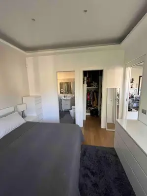 a bedroom with a bed and a living room at Moderno bilocale con terrazzo in Rome