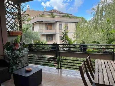 a balcony with a wooden table and a building at Moderno bilocale con terrazzo in Rome