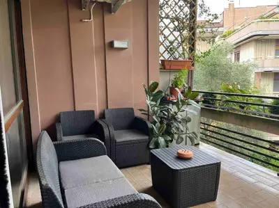 a balcony with chairs and a table on a balcony at Moderno bilocale con terrazzo in Rome