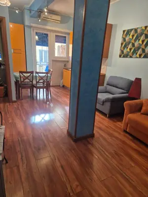 a living room with a table and a couch at Olimpia Apartment in Rome