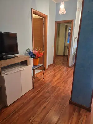 a bedroom with a bed and a table and a mirror at Olimpia Apartment in Rome