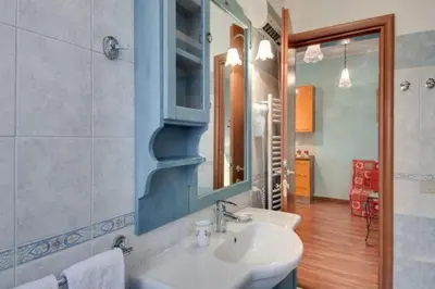 a bathroom with a sink and a mirror at Olimpia Apartment in Rome