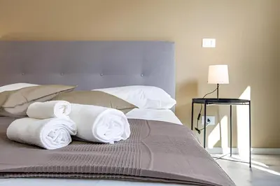 a bed with towels on top of it at 1 Minute from San Pietro - Nicole House in Rome