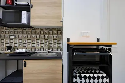 a kitchen with a sink and a microwave at 1 Minute from San Pietro - Nicole House in Rome