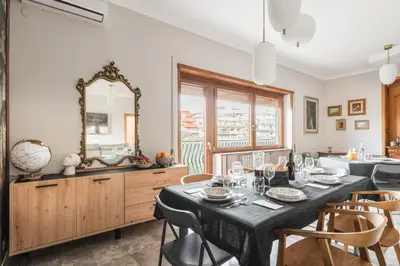 a dining room and living room with a table and chairs at Dalia's Place in Rome