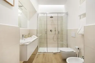 a bathroom with a shower and a toilet and a sink at AlbaDea Apartment in Rome