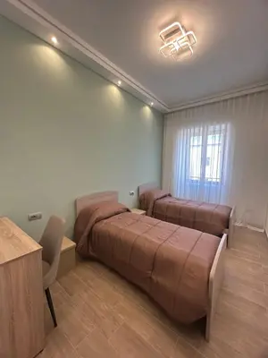 a bedroom with two beds and a table and a desk at Claire House in Rome