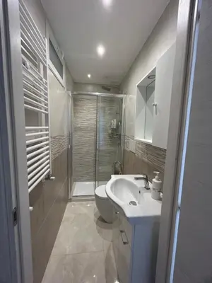 a bathroom with a toilet and a sink and a shower at Claire House in Rome