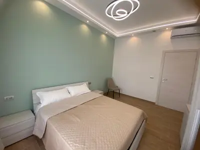 a bedroom with a large bed and a ceiling at Claire House in Rome