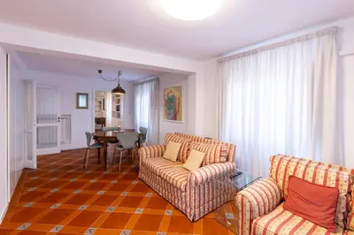 a living room with two chairs and a table at Parlamento Luxury Apartment in Rome