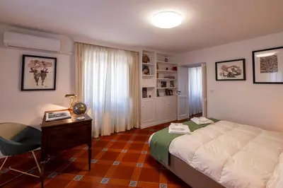 a bedroom with a bed and a desk and a desk at Parlamento Luxury Apartment in Rome