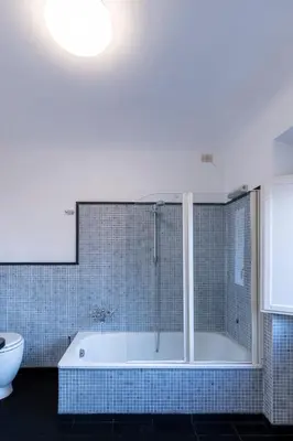 a bathroom with a bath tub and a toilet at Parlamento Luxury Apartment in Rome