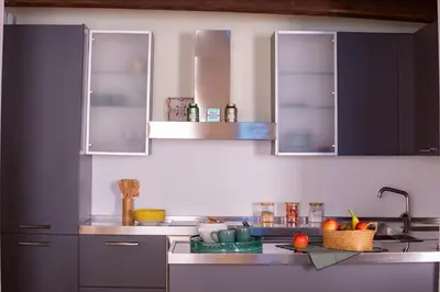 a kitchen with blue cabinets and a counter top at Pantheon Luxury House - ZEN 28 in Rome