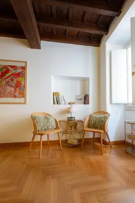 a living room with two chairs and a table at Pantheon Luxury House - ZEN 28 in Rome