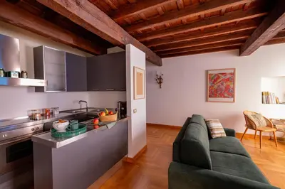 a living room with a couch and a kitchen at Pantheon Luxury House - ZEN 28 in Rome
