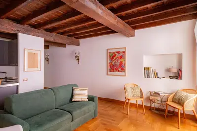 a living room with a green couch and chairs at Pantheon Luxury House - ZEN 28 in Rome