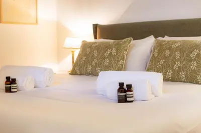 a bedroom with a bed with towels and bottles on it at Pantheon Luxury House - ZEN 28 in Rome